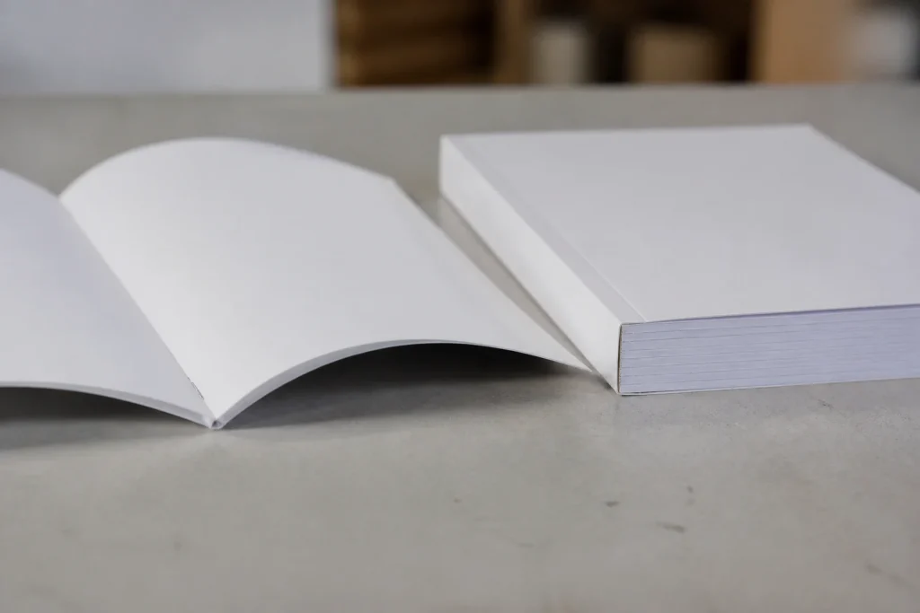 Stapled A5 booklet beside a perfect bound A5 book.