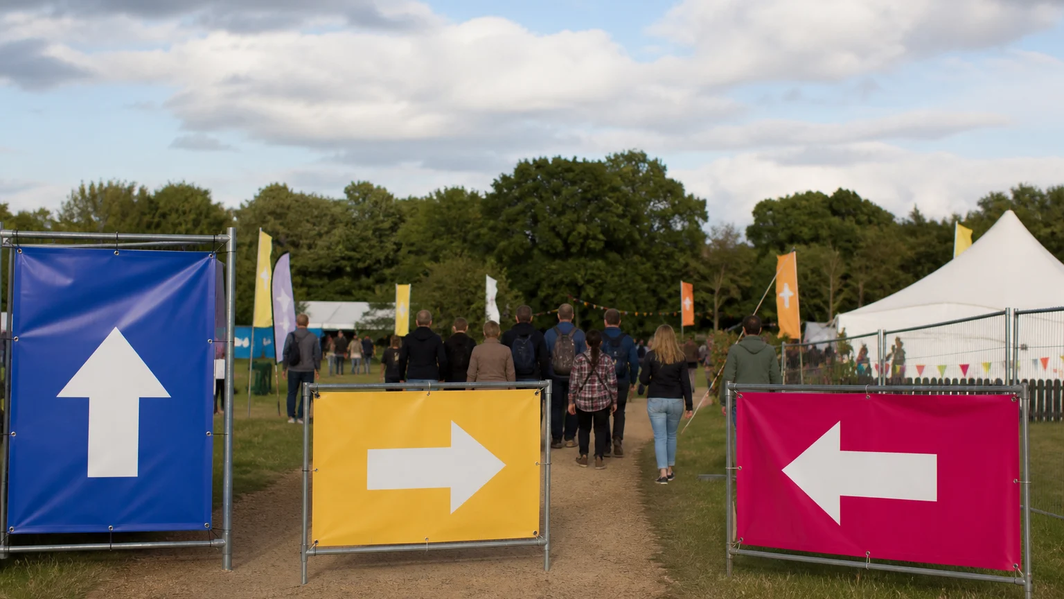 PVC banners guiding visitors through an outdoor event entrance