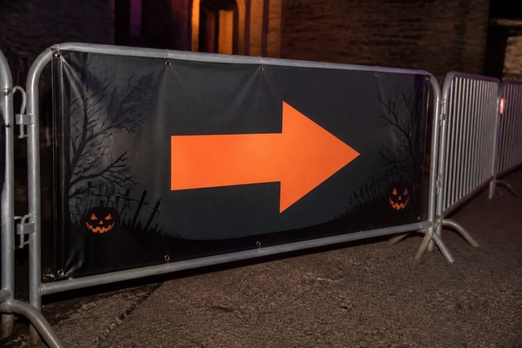 High-contrast Halloween queue banner design with a directional arrow
